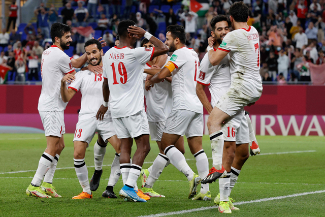Jordan's players celebrate their third goal during the FIFA Arab Cup 2021 group C football match between Jordan and Palestine at the 974 Stadium in the capital city of Doha on Tuesday (AFP photo)