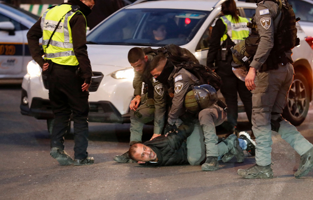 Israeli forces detain a Palestinian man following confrontations with Israeli settlers and a visit by Israeli lawmaker Itamar Ben Gvir of the far-right Religious Zionism alliance (unseen) in the East Jerusalem neighbourhood of Sheikh Jarrah on Sunday (AFP photo)