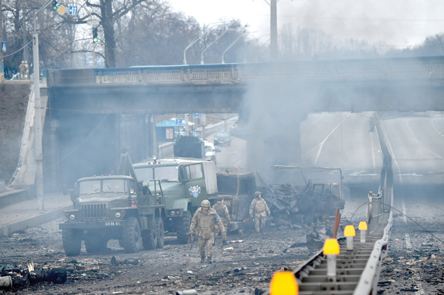 Ukrainian service members are seen at the site of a fighting with Russian a raiding group in the Ukrainian capital of Kyiv on Saturday morning, according to Ukrainian service personnel at the scene (AFP photo)