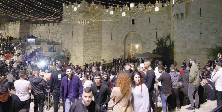 Palestinians gather outside the Damascus gate in Jerusalem's Old City on Saturday (AFP photo)