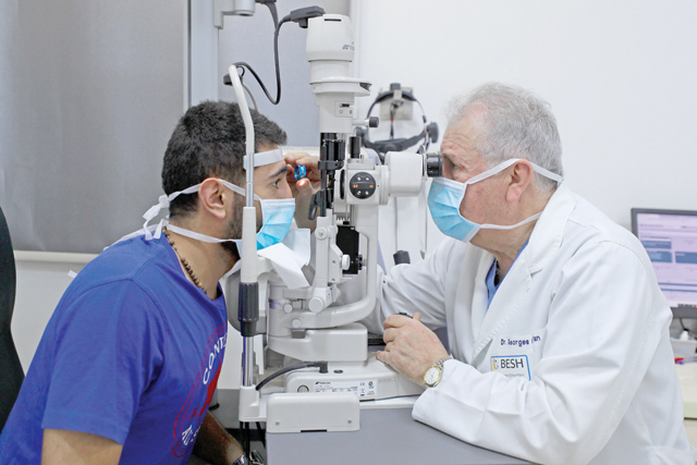 Lebanese ophthalmologist George Cherfan examines a patient's eyes at the Beirut Eye and ENT specialist hospital in the Iraqi capital Baghdad, on Saturday (AFP photo)