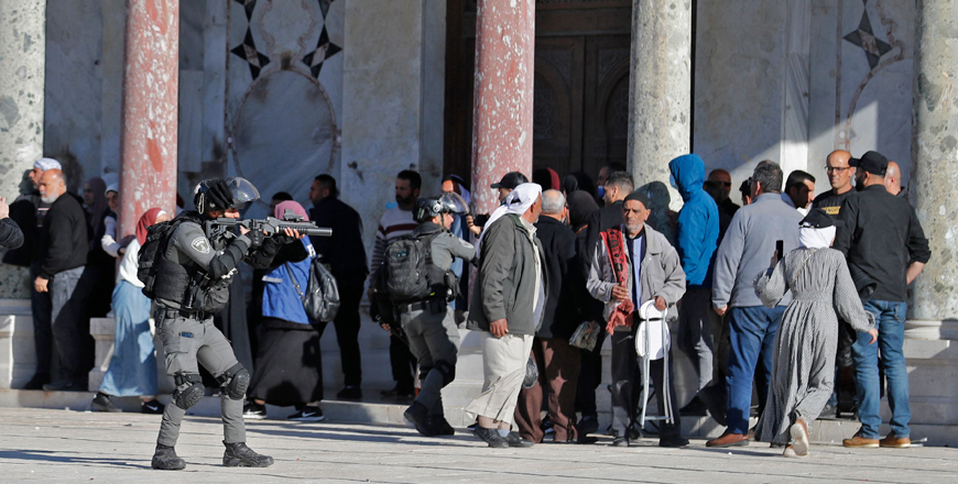 Palestinians kept at bay by Israeli soldiers during confrontations at Jerusalem’s Al Aqsa Mosque compound, on Friday (AFP photo)