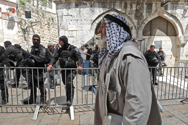 An elderly Palestinian man in the Old City of Jerusalem on his way back from Al Aqsa Mosque compound after taking part in the Friday Prayer on Friday (AFP photo)