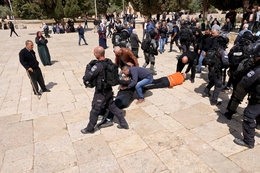 Two people lie on the ground during confrontations between Palestinians and Israeli forces on Thursday following a visit by a group of Jewish people at the Al Aqsa mosque compound (AFP photo)