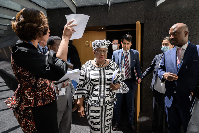 World Trade Organisation Director-General Ngozi Okonjo-Iweala (centre) leaves a press conference at the start of a four-day WTO Ministerial Conference in Geneva on Sunday (AFP photo)