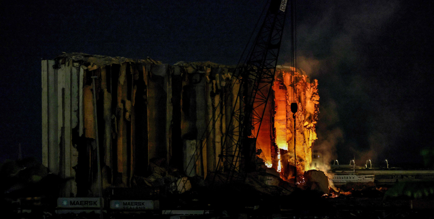 Part of the silos in the port of the Lebanese capital Beirut, which were destroyed in a massive explosion on August 4, 2020, burn during the night of Thursday (AFP photo)
