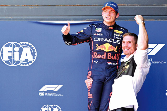 Red Bull Racing’s Dutch driver Max Verstappen celebrates with Dutch Kickboxer Rico Verhoeven after he took the pole position during the qualifying session ahead of the Dutch Formula One Grand Prix at the Zandvoort circuit on Saturday (AFP photo by Andrej Isakovic)