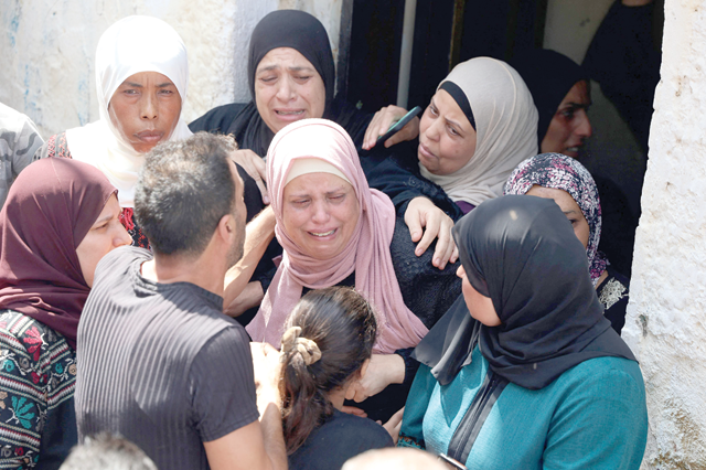 The mother (centre) of Palestinian Yunis Ghasan Tayeh, 21, mourns during his funeral at the Al-Faraa refugee camp near Tubas in the occupied West Bank, on Wednesday (AFP photo)
