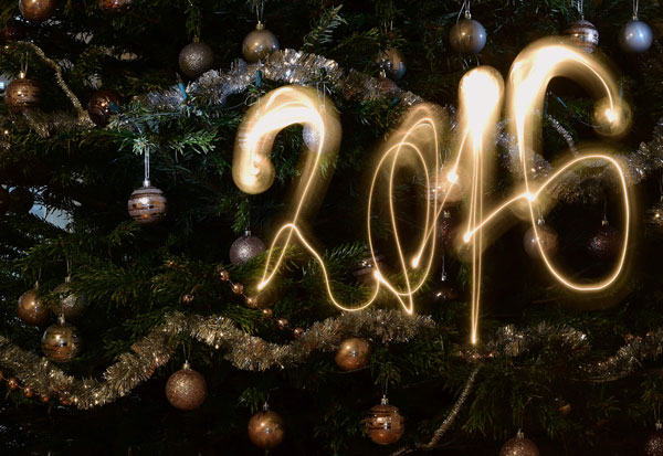 This long-exposure photo taken in Budapest on Thursday shows the New Year 2016 written with a flashlight in front of a Christmas tree  (AFP photo by Attila Kisbenedek)