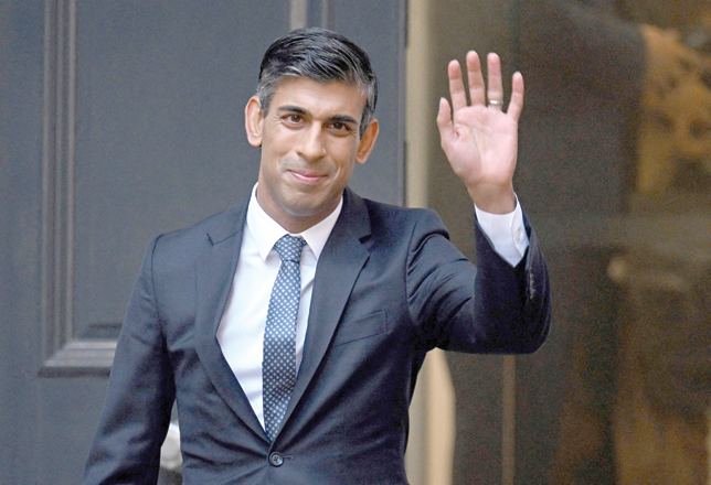 New Conservative Party leader and incoming prime minister Rishi Sunak waves as he leaves from Conservative Party headquarters in central London having been announced as the winner of the Conservative Party leadership contest, on Monday (AFP photo)