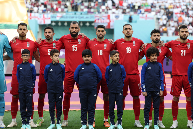 Iran players listen to the national anthem ahead of the Qatar 2022 World Cup Group B football match between England and Iran at the Khalifa International Stadium in Doha on Monday (AFP photo)