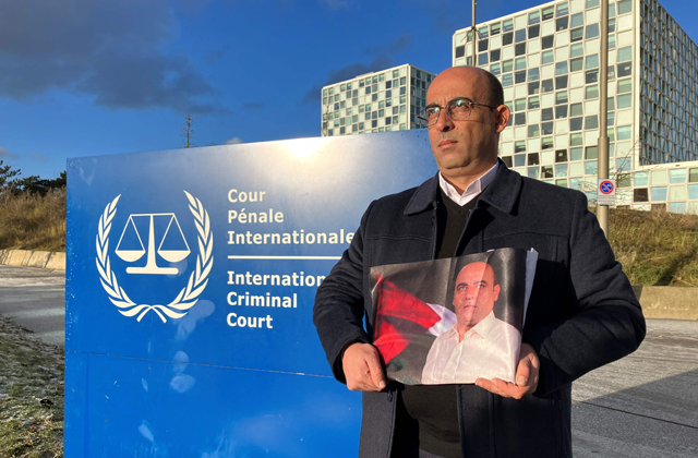 Ghassan Banat, brother of late Palestinian activist Nizar Banat, holds a picture of his brother outside the International Criminal court (ICC) in the Hague, after submitting a case accusing top Palestinian officials over his death in custody (AFP photo)