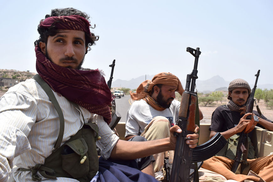 Yemeni fighters, loyal to exiled President Abed Rabbo Mansour Hadi, sit in the back of a pick up truck in the city of Daleh, 280 kilometres south of the capital Sanaa, on Sunday (AFP photo)