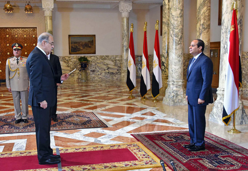 In this photo provided by Egypt's state news agency MENA, Egyptian President Abdel Fattah Al Sisi presides over the swearing in of Prime Minister Sharif Ismail (left) one week after the previous Cabinet resigned amid a corruption probe in Cairo, Saturday (AP photo)