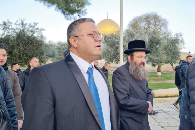 This  handout photo shows Israeli minister and Jewish Power Party chief Itamar Ben-Gvir (centre) walking through the courtyard of Jerusalem's Al Aqsa Mosque compound on Tuesday (AFP photo)