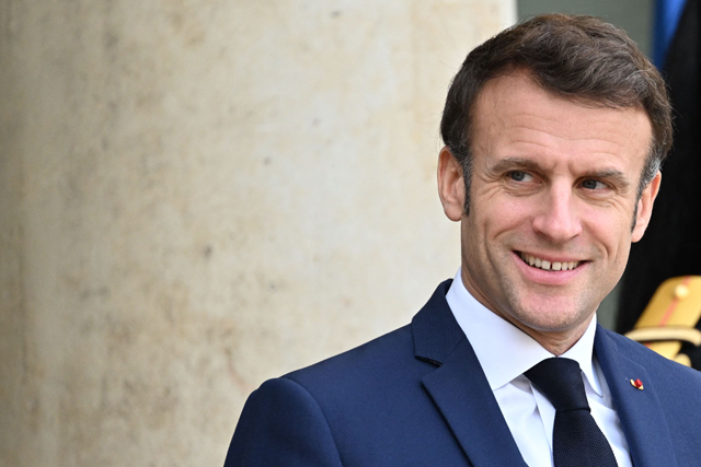 French president Emmanuel Macron smiles at photographers at the Elysee Palace in Paris on January 11 (AFP photo)