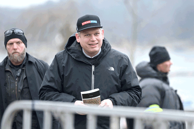 The leader of the far-right Danish political party Stram Kurs, Swedish-Danish politician Rasmus Paludan is pictured while holding the Koran while staging a protest outside the Turkish embassy in Stockholm, Sweden, on Saturday (AFP photo)