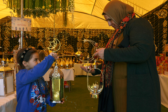 Palestinians shop at a Ramadan lantern or 'fanous' stall, ahead of the holy Muslim month, in Hebron in the occupied West Bank on March 16 (AFP photo)