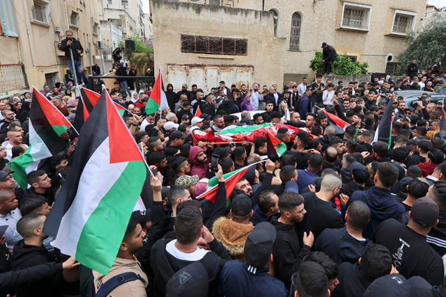 Palestinian mourners carry the body of Amir Imad Abu Khadija, who was killed in an Israeli raid, during his funeral on Thursday in Tulkarem in the occupied West Bank (AFP photo)