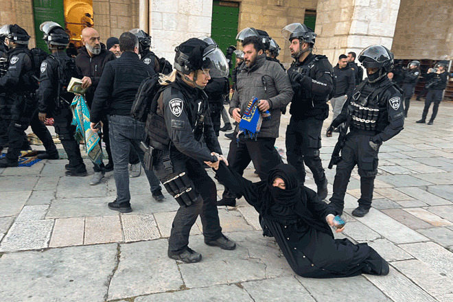Israeli forces remove Palestinian Muslim worshippers sitting on the grounds of the Al Aqsa Mosque compound in Jerusalem, early on Wednesday during the holy month of Ramadan (AFP photo)