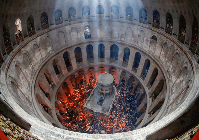 In this file photo taken on April 23, 2022, Orthodox Christians gather with lit candles around the Edicule, traditionally believed to be the burial site of Jesus Christ, during the Holy Fire ceremony at Jerusalem's Holy Sepulchre Church (AFP photo)