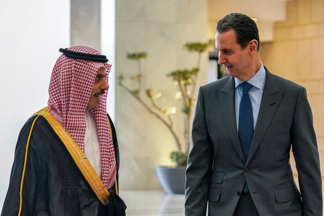 This handout photo released by the Syrian Presidency Facebook page shows Syria's President Bashar Al Assad (right) receiving Saudi Arabia's Foreign Minister Faisal Bin Farhan in Damascus on Tuesday (AFP photo)