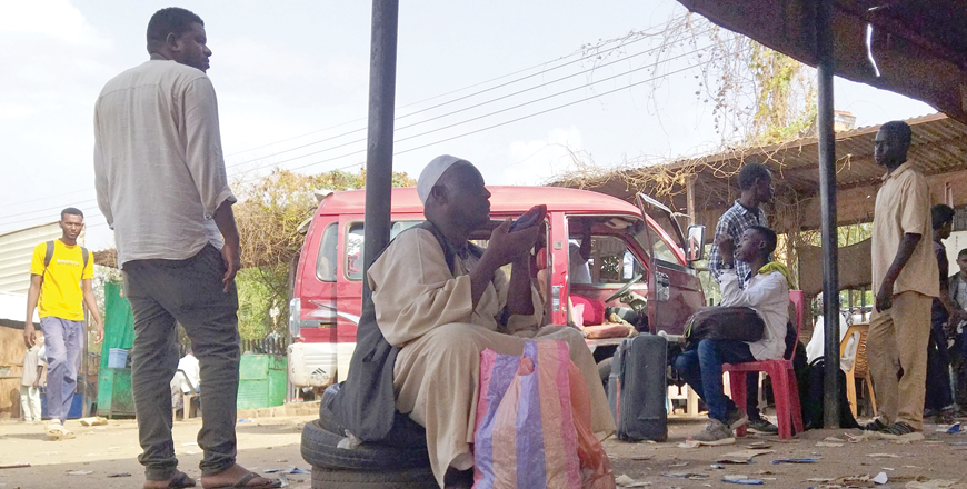 People wait at a bus station in Wad Madani, the capital of Sudan's Al Jazirah state, on Tuesday as they face limited access to transportation and a surge in fuel prices amid ongoing fighting in Sudan (AFP photo)