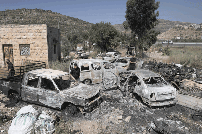 A photo shows burnt cars, reportedly set ablaze by Israeli settlers, in the area of Al Lubban Al Sharqiya in the occupied West Bank on Wednesday (AFP photo)