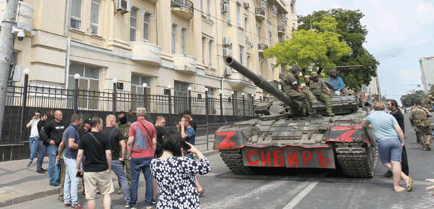 Members of Wagner group sit atop of a tank in a street in the city of Rostov-on-Don, on Saturday (AFP photo)