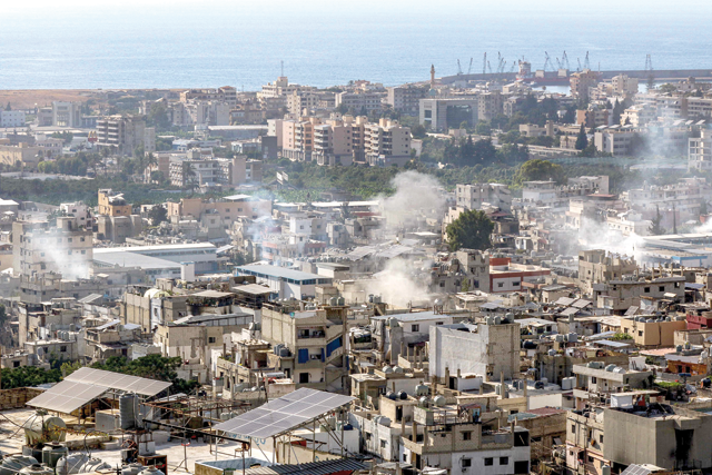 Smoke billows during clashes at the northern edge of the Ain Al Helweh camp for Palestinian refugees, in Lebanon's southern coastal city of Sidon, on Tuesday (AFP photo)