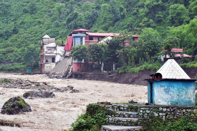 A portion of college building is seen collapsed along the river Maldevta after heavy rains in Dehradun on Monday (AFP photo)