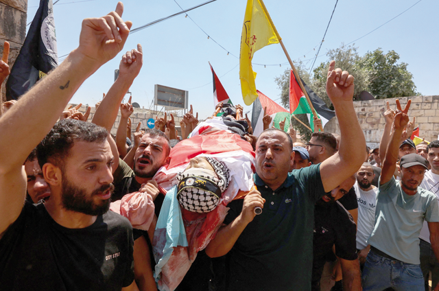 Palestinians carry the body of Othman Abu Khurog, 17, during his funeral in the village of Zababdeh near Jenin in the occupied West Bank on Tuesday (AFP photo)
