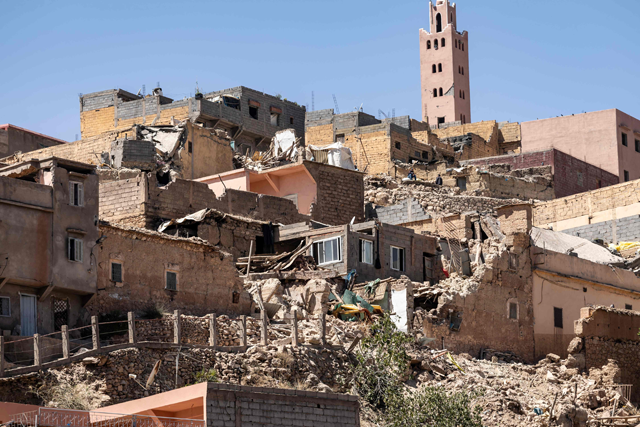 The minaret of a mosque stands behind damaged or destroyed houses following an earthquake in Moulay Brahim, Al Haouz province, on Saturday (AFP photo)