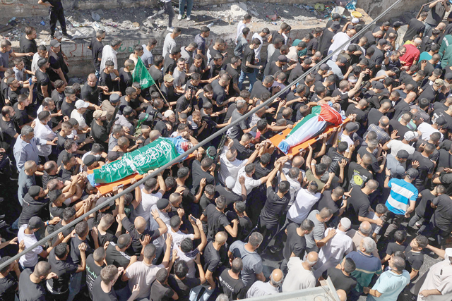 Mourners carry the body of Palestinians killed in an Israeli raid Osaid Abu Ali (left), 21, and Abd Al Rahman Abu Daghash, 32, during their funeral at the Nur Shams refugee camp near the northern city of Tulkarem in the occupied West Bank on Sunday (AFP photo)