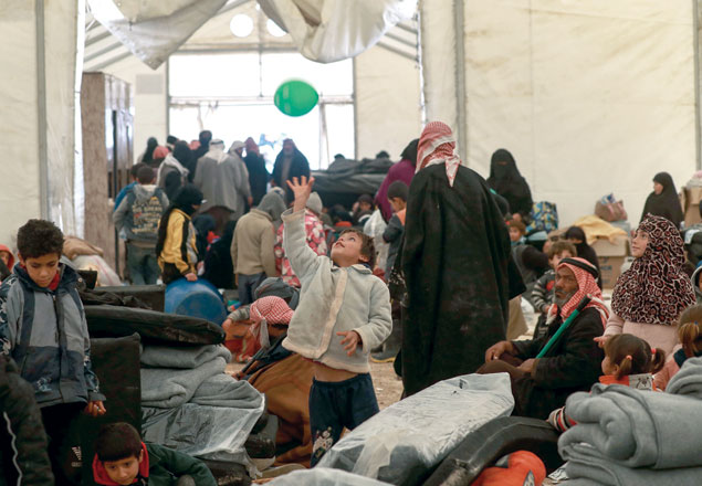 A Syrian displaced kid plays with a balloon inside a tent in the Internallly Displaced People camp of Al Hol in Al Hasakeh Governorate in northeastern Syria on Saturday (AFP photo)