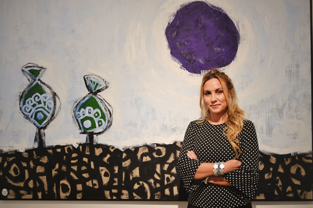 Artist Nissa Raad poses in front of one of her paintings at the opening of her solo exhibition ‘ZEN’ on Saturday  (Photo by Ana Ibáñez Prieto)