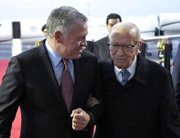   His Majesty King Abdullah is received by Tunisian President Beji Caid Essebsi on Saturday as he arrives in Tunis to head the Jordanian delegation to the Arab summit  (Photo courtesy of Royal Court)