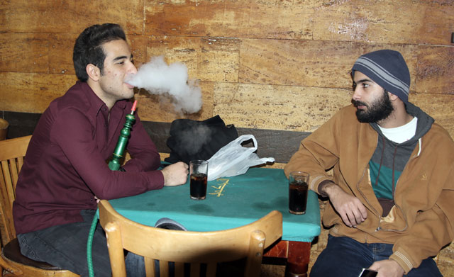 A young man smokes argileh at a café in Amman on Wednesday (Photo by Osama Aqarbeh)