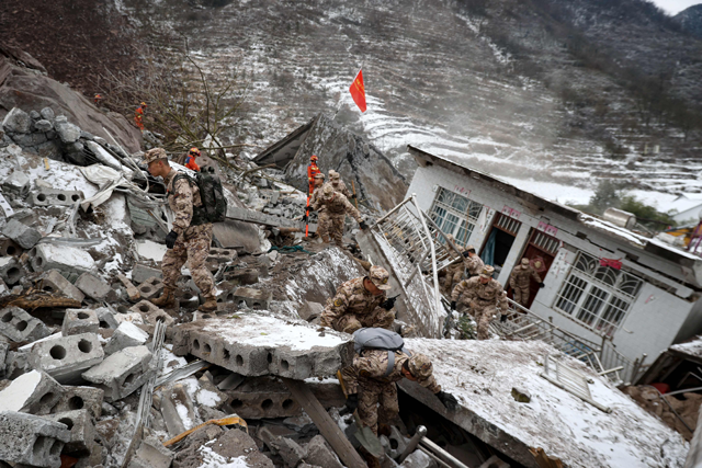 Chinese military personnel and rescue workers search for missing victims following a landslide in Liangshui village at Zhaotong, in southwestern China's Yunnan province on Monday (AFP photo)