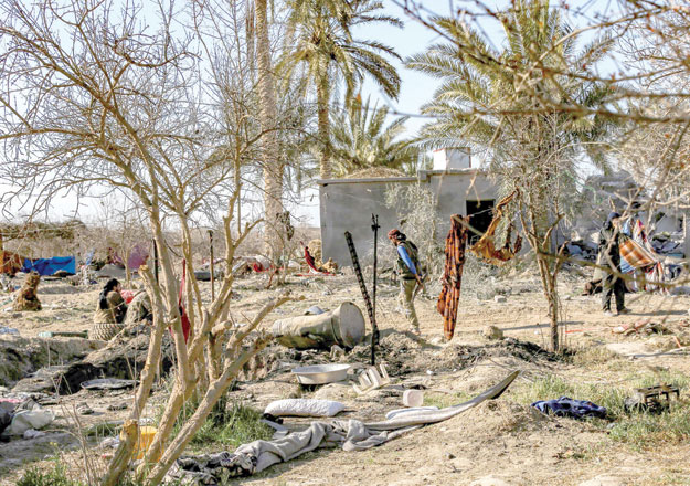 Fighters with the Syrian Democratic Forces check a makeshift camp for Daesh group members and their families in the town of Baghouz, in the eastern Syrian province of Deir Ezzor, on Saturday (AFP photo)