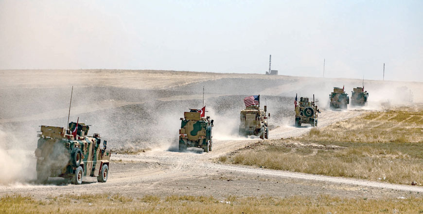 Turkish and US military vehicles take part in joint patrol with Turkish troops in the Syrian village of Al Hashisha on the outskirts of Tal Abyad town along the border on Sunday (AFP photo)