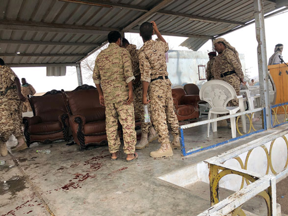 Soldiers inspect the scene of a Houthi drone attack at Yemeni government military parade in Al Anad airbase, Lahaj province, Yemen, on Thursday (Reuters photo)