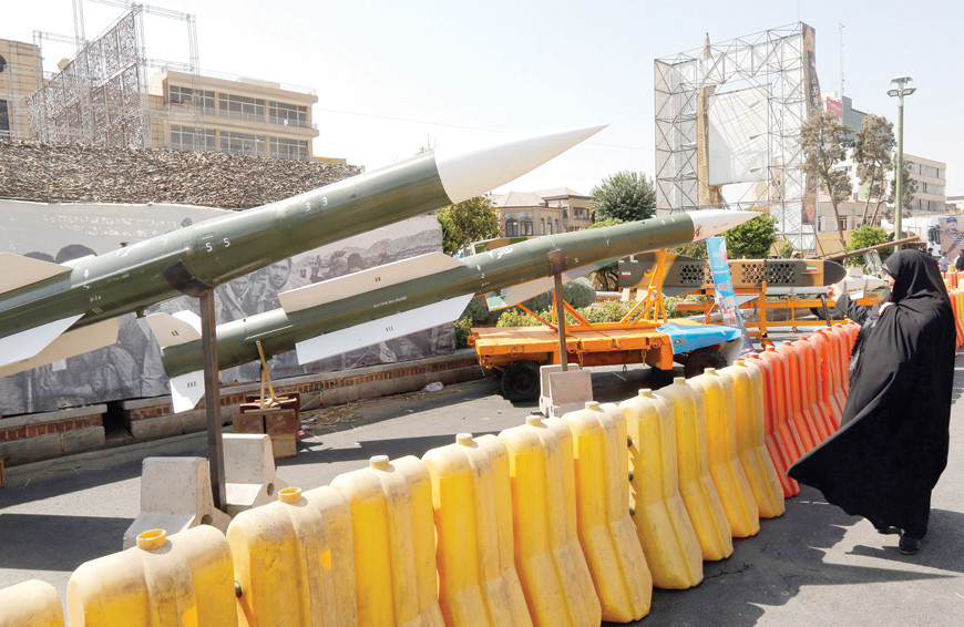 An Iranian woman looks at Taer-2 missile during a street exhibition by Iran's army and paramilitary Revolutionary Guard celebrating 'Defence Week' marking the 39th anniversary of the start of 1980-88 Iran-Iraq war, at the Baharestan Square in Tehran, on Thursday (AFP photo)