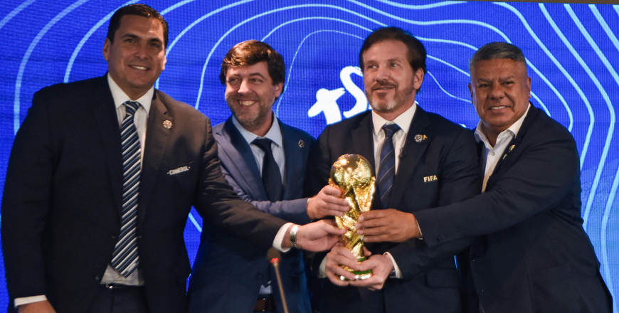 Left to right: Paraguayan Football Association President Robert Harrison, Uruguayan Football Association President Ignacio Alonso, Conmebol President Alejandro Dominguez and Argentine Football Association President Claudio Tapia hold a replica of the World Cup trophy after announcing in a press conference in Luque, Paraguay, on Wednesday (AFP photo)