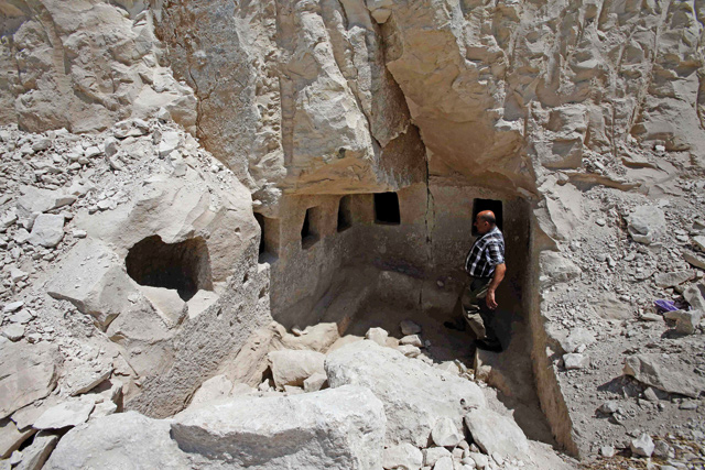 Taleb Jubran, director of the department of tourism and antiquities in Hebron, stands in an ancient burial site from the Roman-era which was discovered during construction of a new road in Idna village, northwest the West Bank city of Hebron, on Thursday (AFP photo)