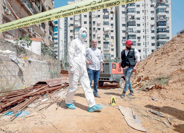 This photo taken on Sunday shows forensic investigators of Lebanon's military intelligence inspecting the scene where two drones came down in the vicinity of a media centre of the Shiite Hizbollah movement earlier in the day (AFP photo)