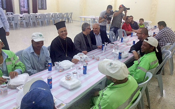 Sanitation workers break their fast at an iftar banquet hosted by the Saint Elias Melkite Greek Catholic Church in Marj Al Hamam recently (Photo by Rula Samain)