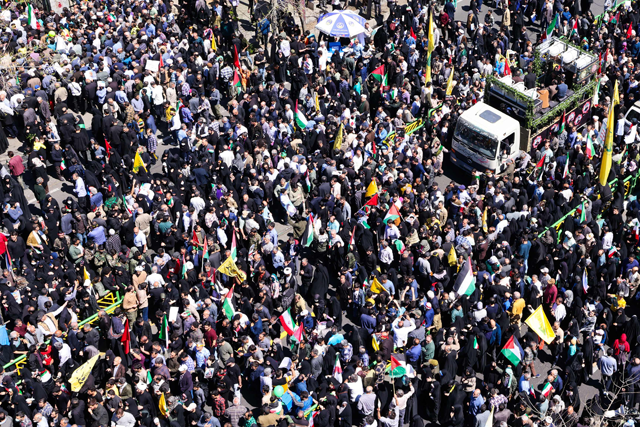 People attend the funeral procession for seven Islamic Revolutionary Guard Corps members killed in a strike in Syria, which Iran blamed on Israel, in Tehran on Friday (AFP photo)
