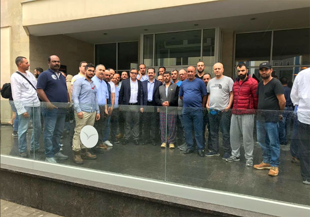   Jordan’s Ambassador in Kazakhstan Yousef Abdul Ghani poses for a photo with Jordanian engineers working at a construction company in Kazakhstan, following an assault on the company’s Arab employees, in Atyrau, Kazakhstan, on Sunday (Photo courtesy of Foreign Ministry)