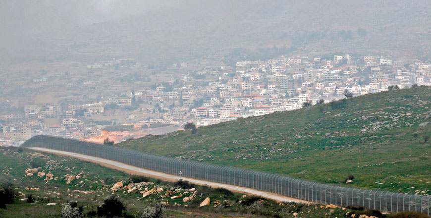 This photo taken on Monday, shows the Israeli defensive fence separating the Israeli-occupied sector of the Golan Heights and the Druze city of Majdal Shams (background) from Syria (right) (AFP photo)